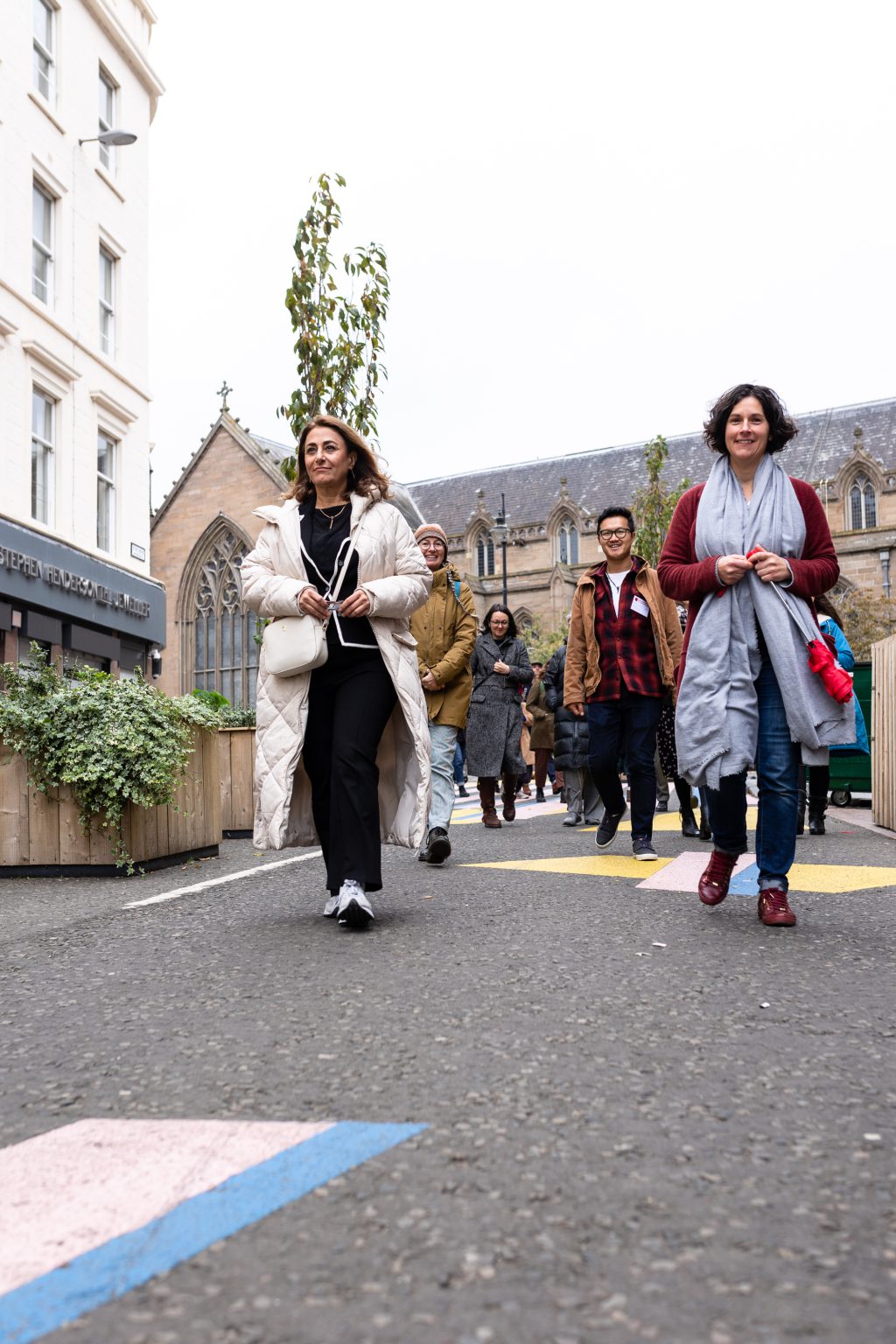 Participants walk down a street in Dundee.